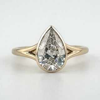 Bezel Pear Solitaire Ring with pear-cut diamond in bezel setting on yellow-gold band